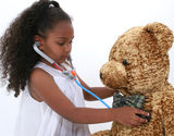 Adorable Little Playing Doctor To A Teddy Bear Over White Royalty Free Stock Photography