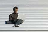 College Age Student Studies from Laptop Royalty Free Stock Photo