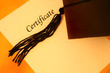 Certificate and graduation cap Stock Photography