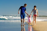 Young family on the beach Stock Photos