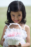 Pretty lass in flower girl attire Stock Images
