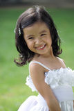 Pretty lass in flower girl attire Stock Photos