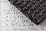 Scientific calculator on math textbook Royalty Free Stock Photos