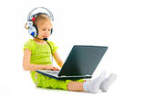 Girlie in earphones with laptop Stock Images