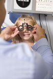 Optometrist in exam room with young girl Royalty Free Stock Image