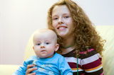 Teenager with newborn brother Stock Photo