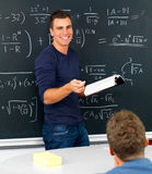 Teacher teaching mathematics in classroom Stock Images
