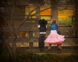 Boy and girl on fence Stock Photography