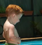 Redheaded boy holding his belly Royalty Free Stock Photos