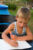 The little boy studies to write Stock Image