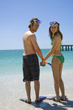 Young couple on beach snorkel Stock Image