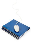 Blue school textbook and computer mouse Royalty Free Stock Images