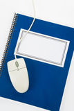 Blue school textbook and computer mouse Stock Photography