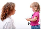 Little girl studies female doctor Royalty Free Stock Photo