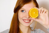Redheaded  girl with orange Royalty Free Stock Images
