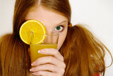 Redheaded  girl with orange Stock Photos