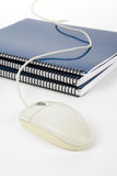 Blue school textbook and computer mouse Royalty Free Stock Photos