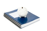 Blue school textbook and piggy bank Stock Image
