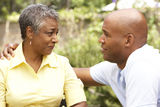 Senior Woman Being Consoled By Adult Son Royalty Free Stock Image