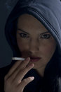 Smoking woman with hood in night Royalty Free Stock Photos