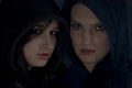 Bad girls with hood in darkness Stock Photos