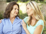Senior Woman Being Consoled By Adult Daughter Stock Photos
