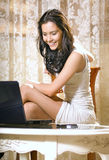 Girl with notebook computer at home Stock Photography