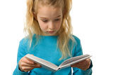 Young girl is reading a book Stock Images