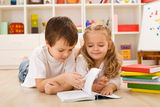 School boy teaching her sister how to read Royalty Free Stock Photography
