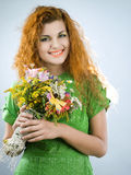 Redheaded girl with bouquet Royalty Free Stock Photography