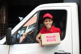 Delivery courier in truck handing over package Royalty Free Stock Photo