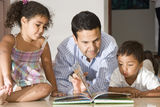 Dad teaching children Stock Photography