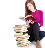 Young girl is sitting on a floor and reading book Stock Photography