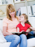 Mother studing her daughter to read Royalty Free Stock Photo