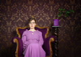 Stern lady in a purple setting Stock Images