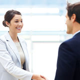 Female executive shaking hands with her coworker Royalty Free Stock Photo