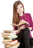 Young girl is sitting on a floor and reading book Stock Photography