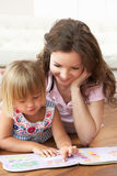 Mother And Daughter Learning To Read At Home Stock Images