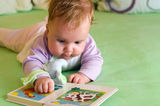 Baby girl reading Stock Photo