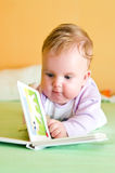 Baby girl reading Stock Photos
