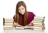 Young girl sitting at the desk and reading book Stock Photo