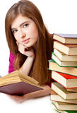 Young girl is lying on a floor and reading book Royalty Free Stock Photos