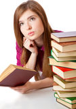 Young girl is lying on a floor and reading book Stock Photography