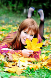 Redheaded gril in autumn forest Stock Images