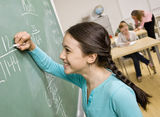 Student writing on blackboard Stock Image