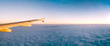 Plane wing over clouds Stock Photos