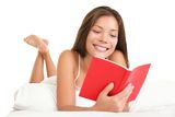 Woman reading book in bed Stock Photo
