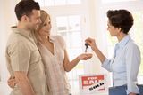 Estate agent handing over keys Royalty Free Stock Images