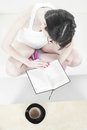 Young woman relaxing in a sofa and reading a book Stock Photo