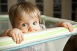 Baby looking over playpen Royalty Free Stock Photo
